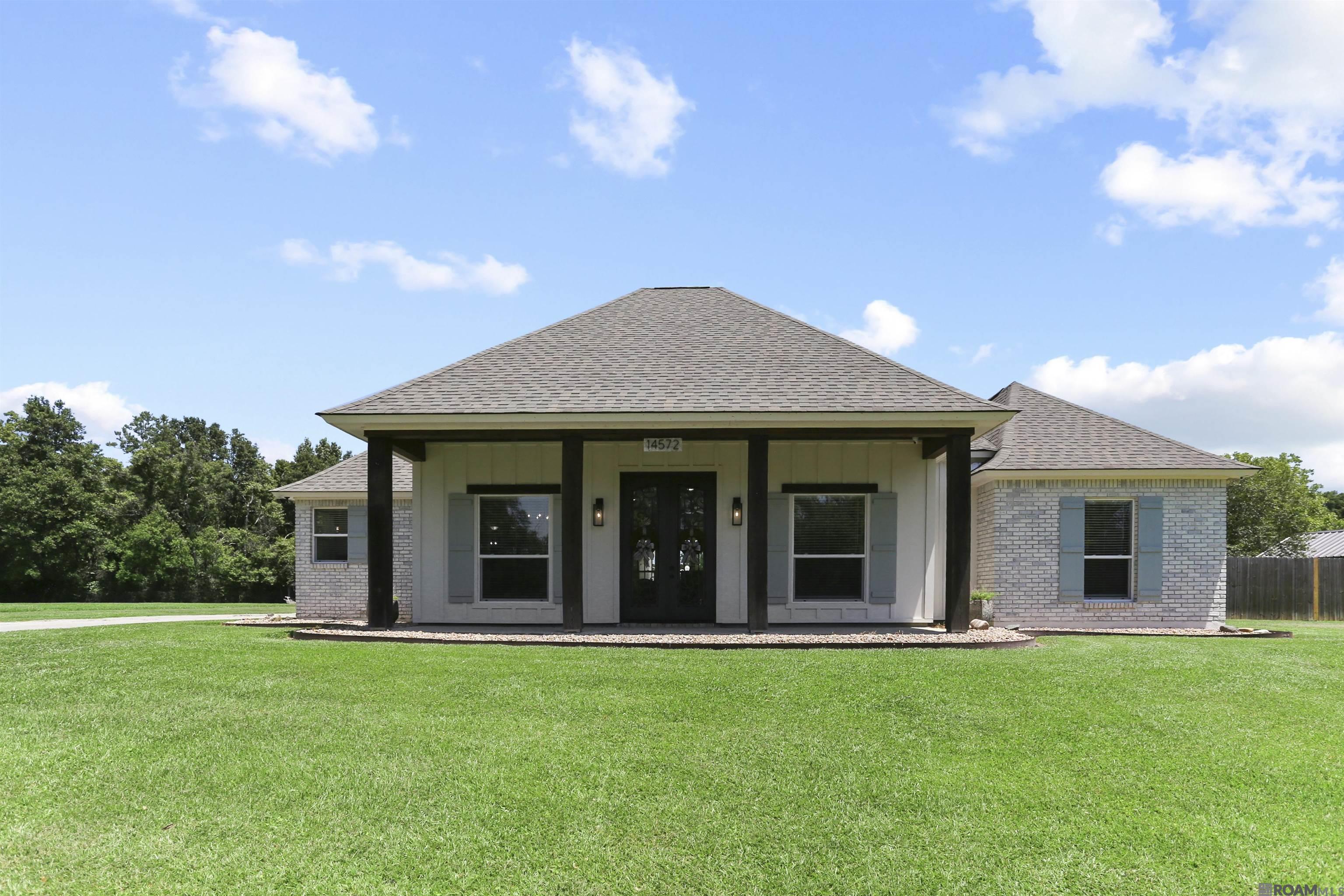Why should you schedule a private tour? Because this is the kind of property that rarely hits the market—and when it does, it doesn’t last long. Situated on 6 beautiful acres on the high side of Bluff Road, this estate offers a one-of-a-kind blend of luxury, functionality & fun. The completely updated main home welcomes you with stately curb appeal, wood beam accents, charming front porch & iron double doors. Inside, you'll find a show-stopping open plan w/ exposed wood beams, oversized leathered granite island, corner sink, gas cooktop, custom pantry door & designer lighting. The kitchen flows into a spacious keeping room & living area w/ bricked gas logs fireplace, built-ins & a wall of windows overlooking the stunning outdoor oasis. The primary suite is a retreat all its own, featuring dual walk-in closets, a freestanding slipper tub, oversized tile shower w/ body jets, dual vanities & private water closet. This home also features 10' ceilings, crown molding, updated appliances & storage. You will love the unique outdoor ½  bath off the carport & whole home generator big enough to power the main house & workshop. Step outside to enjoy your own private resort w/ saltwater pool, water wall, hot tub & sprawling patio area with space for lounging, dining & entertaining under the stars. At the back of the property, a picturesque pond invites lazy days of fishing. Behind the main home is an impressive 2,439 sq-foot insulated workshop w/1 roll up & 2 automatic doors, distressed tin & wood finishes offering the ultimate man cave, hobby space or horse barn. As a bonus, the 1,280 sq-foot guest house—only two years old—features 3 bedrooms, 2 baths, luxury vinyl plank flooring, custom tile showers & open kitchen, living & dining, plus a decked porch perfect for grilling or relaxing. Whether you're looking for peaceful privacy, space for horses & ATVs, or a place to gather & entertain, this property has it all. Schedule your private showing today before this rare gem is gone.