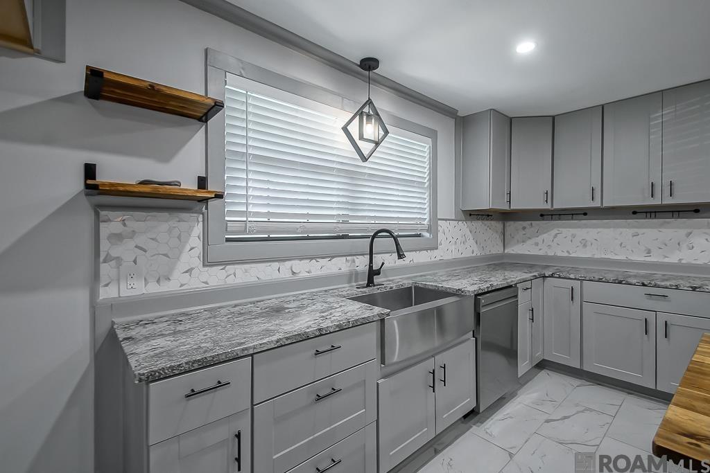 Experience refined country living at its best in this custom-crafted gem! Set on a peaceful 1.836-acre lot near the end of a quiet, one-street neighborhood, this 5-bedroom, 3.5-bath home spans over 4,600 sq ft of thoughtfully designed space across two stories—offering both elegance and functionality!  Blending modern and farmhouse aesthetics, this residence welcomes you with an open-concept layout, oversized rooms, and plenty of storage. Hardwood floors flow throughout the home, paired with porcelain tile in wet areas for durability and style. The heart of the home is the beautiful kitchen, recently updated with luxurious granite countertops.  It also features custom cabinetry, stainless steel appliances, a farmhouse sink, and an expansive 4’ x 8’ island with a wooden countertop—perfect for gatherings or culinary creations. A large walk-in pantry adds functionality, while open sightlines to the foyer, dining area, living room, and sunroom make this an entertainer’s dream. The living room showcases a grand staircase and is one of several spaces warmed by five electric fireplaces thoughtfully placed throughout the home. Glass doors provide panoramic views of the beautifully wooded perimeter, while the wrap-around porch invites you to enjoy serene outdoor moments year-round. The primary suite is a true sanctuary with a spacious layout, sitting area, and fireplace, while the ensuite bath boasts a beautiful, custom double shower, separate garden tub, and elegant finishes that make it feel like your own personal spa. Recent updates in 2023 include a new roof and driveway, PEX plumbing with Kohler fixtures (tubs and toilets), 2 Rheem tankless water heaters, new HVAC system and new interior/exterior doors. This home combines luxury, space, and peace of mind—all just minutes from town and is priced well below appraisal! Schedule your private showing today and see why this home is unlike any other on the market.