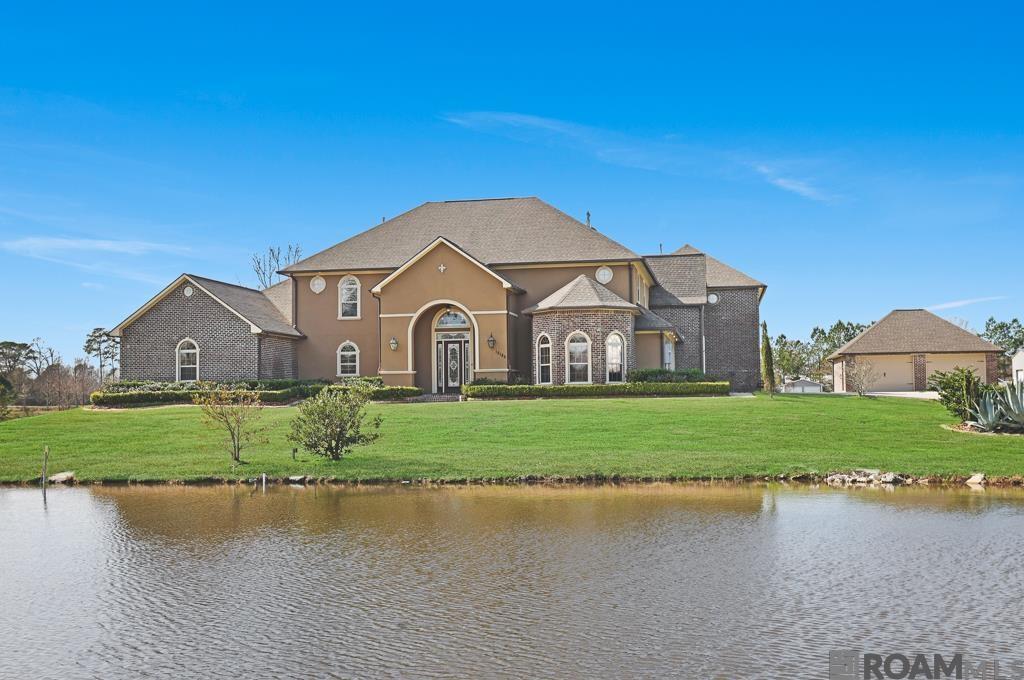 This home has 5 bedroom 4.5 bath, office, multiple bonus rooms and a media room making it a rare find in Ascension Parish.  Don't miss out on this amazing home that checks all the boxes you have been dreaming about.  Driving up to the property you will notice this luxury home sitting on 2.28 acres, with a large pond in the front yard, long driveway and 4 CAR GARAGE!  This home has recently been upgraded with all new interior paint including walls, trim and cabinets.  The seller also upgraded the backsplash and much of the lighting. Entering the home you will step into a beautiful foyer and your eyes will be drawn to the stunning iron staircase and the 20 foot ceilings.  You will love the new light fixtures, large windows letting in tons of natural light, and the fireplace with built-ins around it.  The kitchen has granite countertops, stainless steel appliances, large island and an additional bar space to gather around and share a meal.  The master bedroom is huge and has a nice size sitting area overlooking the backyard, a fireplace and more built-ins The master bedroom also includes 2 massive walk-in closets that you would have a hard time filling up.  The master bath is also large with double vanities, oversize tile shower with multiple shower heads, soaking tub and water closet.  Upstairs you have several bedrooms, a nice landing area, a flex room that could be used for exercise equipment or many other things.  Additionally there is a full media room with a small kitchen area for you to enjoy movies and gaming with friends and family. All ac units have been replaced in the last 5 years and the home has been wired and has the switch installed for a generator.  This home is in flood zone x and has never had any issues with flooding.  Currently priced significantly below last appraisal. Make your appointment today!