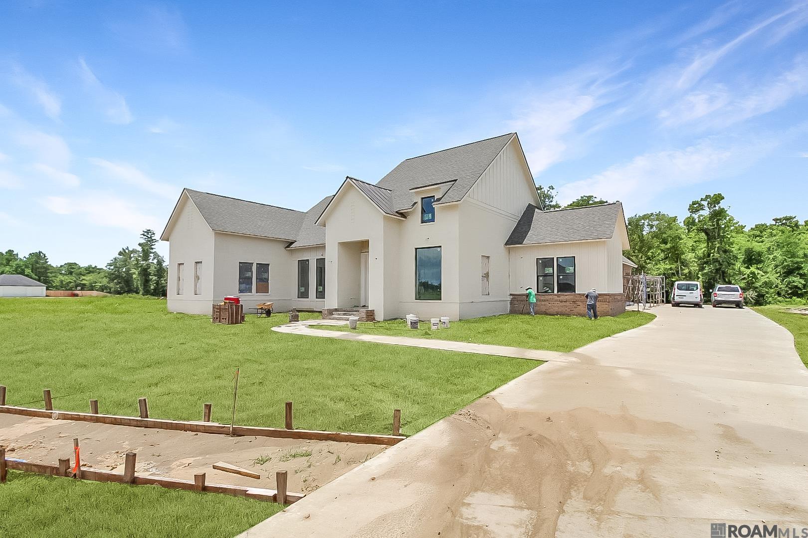 Transitional Farm House with TIMELESS ELEGANCE! Thoughtfully designed 4 Bedroom 3 Bath plus Office/Nursery/Fitness Room with oversized rear porch & Outdoor Kitchen on OVER 1 ACRE LOT in sought after Hidden Lakes Subdivision. Open Kitchen features QUARTZ countertops & island, EXPOSED BEAMS, stainless appliances including 36" GAS COOKTOP, Coffee Bar and a fabulous Back Kitchen with great pantry space. Beautiful WOOD FLOORS throughout Living Room, Dining Room, Kitchen and ALL Bedrooms. Private Master Wing includes awesome Flex Space (Office/Nursey/Fitness), QUARTZ countertops on dual vanities, soaking tub, custom shower and WALK-IN CLOSET with built-ins. Triple Split floorplan has 2 Guest Rooms connected by jack & jill bathroom and 1 Guest Room with en-suite. An entertainer's rear porch has OD Kitchen with BBQ, sink and fridge overlooking the property. OVERSISIZED 2 car garage (~600sqft) plus 3rd bay perfect for your tools and toys! Even has the perfect spot for you to build your separate workshop at the end of driveway!