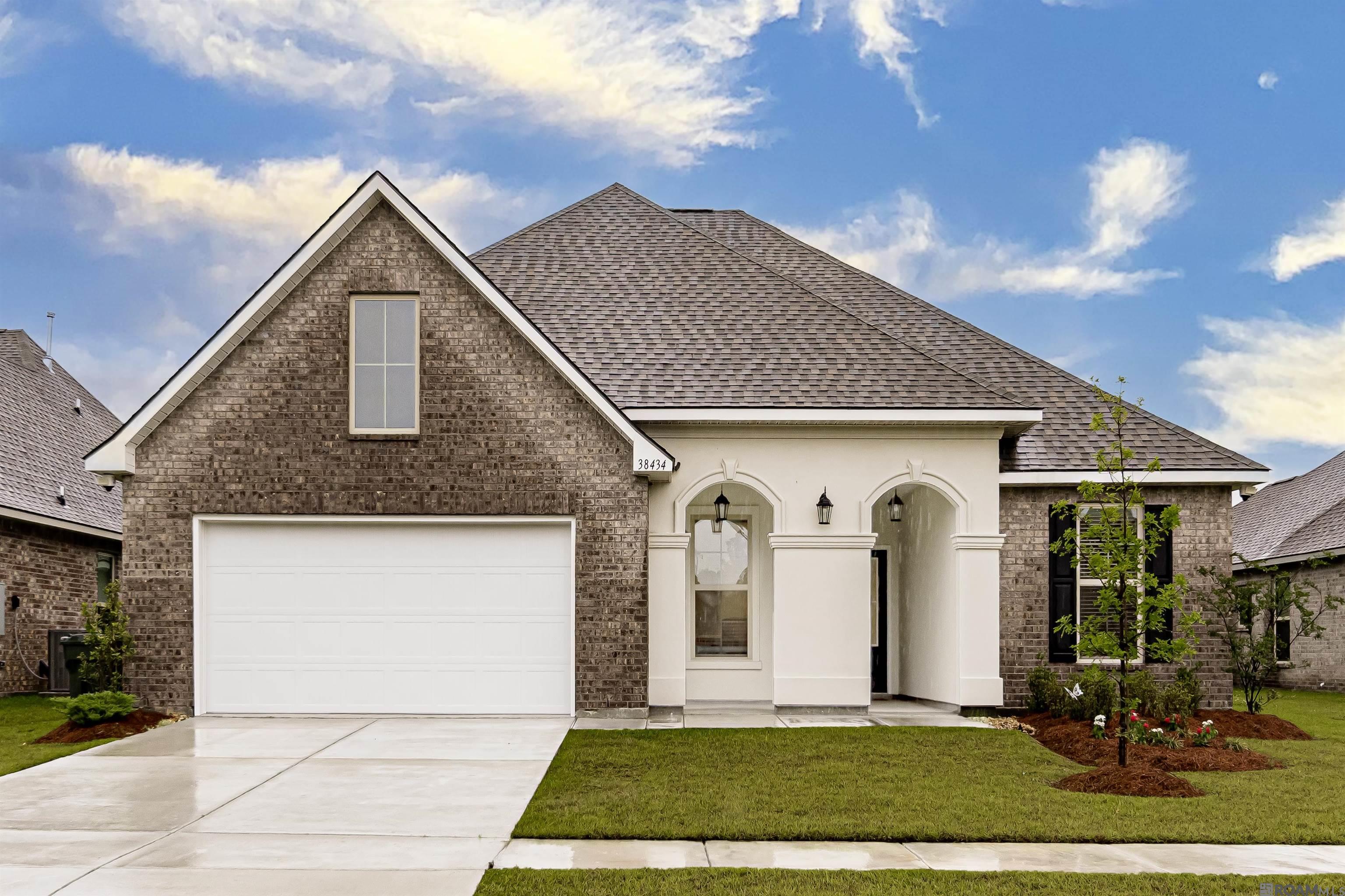 Welcome to your near-new dream home nestled in the highly desirable Windsor Park community of Prairieville. Built in 2023, this spacious 5-bedroom, 3-bath single-family residence offers approximately 2,720 sq ft of thoughtfully designed living space on an 8,058 sq ft lot   .  Layout & Design     •    Expansive open-concept floor plan with a seamless flow between the gourmet kitchen, dining area, and living room—perfect for daily life and entertaining.     •    A formal dining room and a dedicated den/study provide versatile living options.     •    Split bedroom design ensures the primary suite enjoys maximum privacy, while four additional bedrooms offer flexibility for children, guests, or home office space .  ??? Bedrooms & Bathrooms     •    A luxurious primary suite featuring a garden tub, separate shower, dual vanities, and a walk-in closet—with convenient access to the laundry room.     •    Additional bedrooms are well-sized and served by two full baths, each equipped with double-vanity sinks and framed mirrors.  ??? Kitchen & Living Areas     •    A stylish kitchen outfitted with a large island, quartz countertops, a walk-in pantry, and a high-end gas appliance package.     •    The adjoining living area showcases a cozy gas fireplace with a quartz surround and recessed lighting for a comfortable ambiance   .  ?? Exterior & Community     •    Curb appeal abounds with a welcoming covered front porch featuring graceful arches, complemented by a covered rear patio—ideal for family gatherings or quiet relaxation.     •    Professionally landscaped yard, two-car automatic garage with remotes, durable 30-year architectural shingles, and exterior flood lighting enhance functionality and curb appeal.     •    Windsor Park provides lush walking trails, scenic ponds, sidewalks, and serene green spaces. It’s ideally located within minutes of shopping, dining, and entertainment, and zoned for top-rated schools    .  Reach out to schedule a tour today!