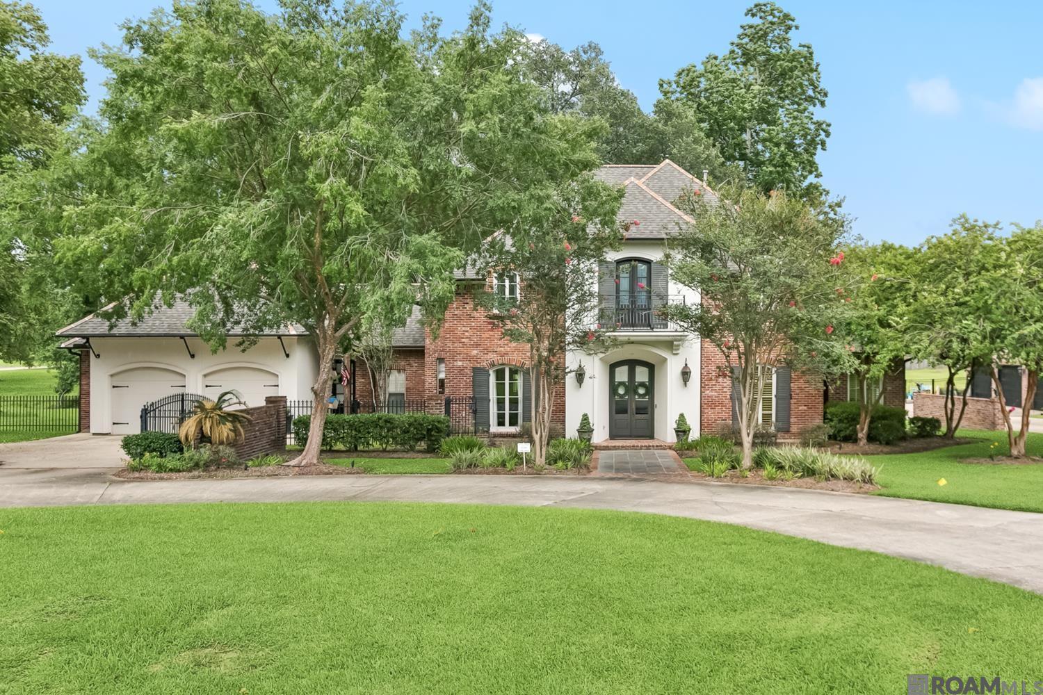 Welcome to your timeless Southern retreat—an elegant 4-bedroom, 3.2-bath home offering over 4,000 square feet of beautifully designed living space on a pristine & private 1-acre lot. Ideally located off Perkins Road between Bluff & Highland, this classic residence blends character, comfort & functionality in one of Baton Rouge’s most desirable areas. From the moment you step inside, the home’s craftsmanship & warmth are undeniable. Reclaimed hardwood floors bring history to the main living areas, while brick pavers in the kitchen add rustic charm. The layout is open yet comfortably segmented, with spacious living & dining areas bathed in natural light from large windows that frame the lush surroundings. The kitchen offers both style & utility, featuring generous prep space, timeless finishes, & a newly installed GE Monogram stainless steel refrigerator (less than a year old). Whether you're entertaining or enjoying a quiet evening, this kitchen is the heart of the home. Upstairs, a versatile bonus room provides endless possibilities—ideal as a playroom, home theater, artist’s studio, or extra lounge. A dedicated office offers privacy for work-from-home needs, while three walk-in attics provide exceptional storage rarely found in modern homes. The four bedrooms are generously sized, including a serene primary suite. Three full baths & two half baths are thoughtfully placed for convenience. Outside, mature oak trees stretch across the expansive backyard, creating beauty, shade, & a peaceful setting for entertaining or relaxing.  Additional highlights include a whole-home generator, French-style gutters, elegant architectural details, 3 year old roof & a flexible layout that supports everyday living. Located in a quiet, established neighborhood, this home offers privacy without sacrificing access to dining, schools, & retail. This Southern gem pairs refined charm, modern updates, & practical features-ready to welcome you home!