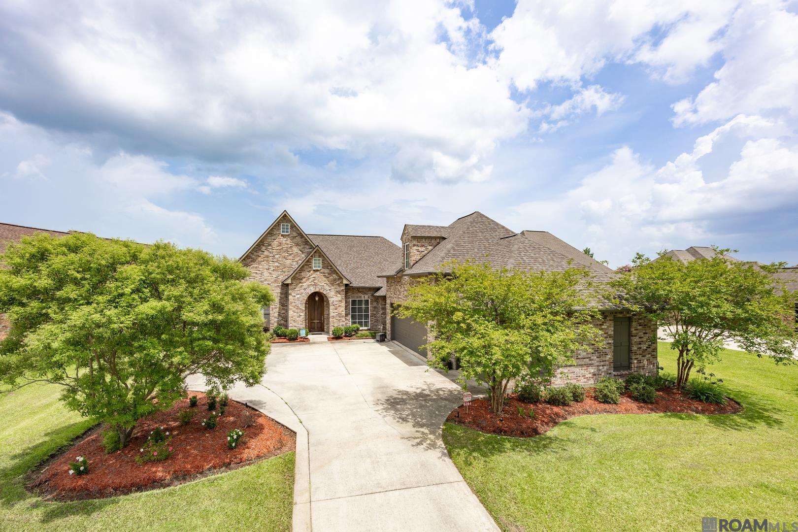 Checks all the boxes! This beautiful, custom designed home features many upscale and trendy amenities. Tons of natural light illuminates the open living areas with brick archways and old wood beams. The gourmet kitchen is every chef's dream with gas range, stainless steel appliances including refrigerator, wide island, and an abundance of cabinets. The luxurious primary bedroom comes with an ensuite bath, boasting a double vanity, deep soaking tub, separate shower and more. There are a total of 4 bedrooms and 3 baths, plus the large bonus room upstairs. Step out back onto the large, screened porch with outdoor kitchen overlooking the golf course and beautiful lake. There is a 3-car garage, and the list goes on. Just vacation at home all year round when you live here. Pelican Point Golf Community offers Championship Golf, 36 fully stocked lakes, tennis courts, Jr. Olympic-size pool, baseball Field, playground, volleyball, jogging trails, nightly security, and much more. Schedule your showing today!