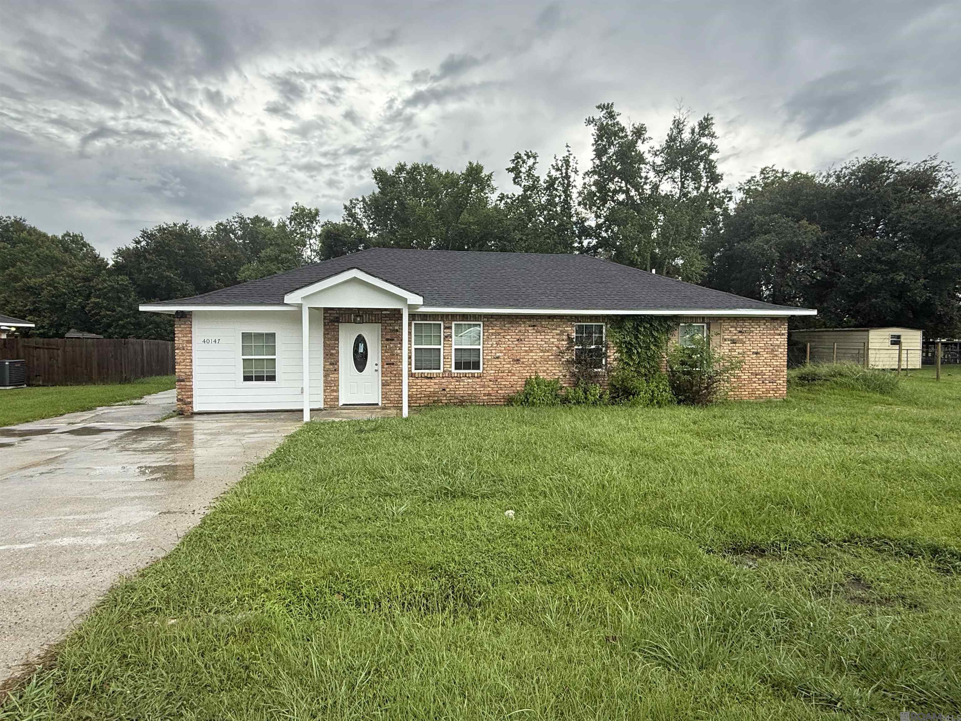 This beautifully updated 3 bedroom, 2 bath home is move in ready and packed with upgrades. Located on a quiet dead end street, it offers peace, privacy, and modern comfort throughout. The kitchen features granite countertops, a large granite island, modern fixtures, and generous cabinet space, perfect for everyday living or entertaining. The open living area includes a custom built in accent wall that adds a stylish focal point! Enjoy spacious bedrooms and updated bathrooms, including a marble tiled tub wall that brings a luxurious touch. Large plank laminate wood flooring flows throughout the home, and the oversized laundry room adds extra convenience.  The roof is approximately 2 years old, offering added peace of mind. Outside, the large yard provides plenty of space to relax, garden, or entertain.  Do not miss this turn key home with thoughtful finishes and timeless charm. Schedule your private showing today.