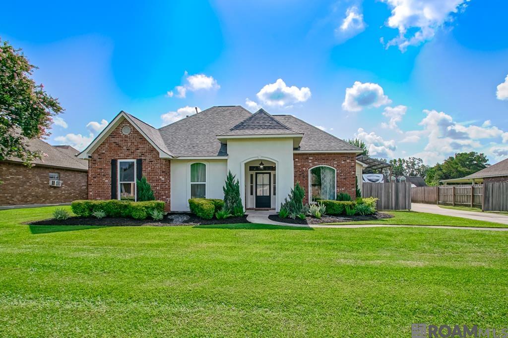 Welcome to your private oasis in Galvez Cove! This beautifully maintained 3- bedroom, 2.5- bath home offers, 1,928 square feet of comfortable, stylish living on Ascension Parish's most sought-after school districts. Tucked away in a quiet one-street neighborhood with NO HOA, this property is a rare find.  Step inside to discover gorgeous hardwood floors throughout, fresh paint, and abundant natural light streaming through brand new windows. The thoughtful floor plan provides both function and flow, perfect for everyday living and entertaining.  Outside, the home truly shines. The lush, professionally landscaped yard creates a serene retreat, centered around a sparkling gunite pool with a waterfall feature, the ultimate backdrop for relaxation or weekend gatherings. An extended patio cover offers plenty of shaded space for outdoor dining and lounging, while the pole barn cover extra versatility and storage.    Additional upgrades include a new roof, and with no HOA, you'll enjoy added freedom and flexibility. Homes like this don't come along often so schedule your private showing today and experience this paradise for yourself. This property did not flood and does not require flood insurance.