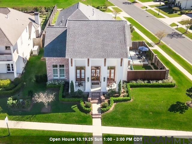 Minutes from Highland Rd/Baton Rouge, In the New Ascension Parish Prairieville High School District! Custom Built, Corner Lot, 4 Bds, 3.5 Baths Sep Office, 3 Car Garage, Gunite Pool w/Hot Tub & Outdoor Living Spaces w/Extensive Upgrades. 2 Story Contemporary featuring a well-designed open floor plan that overlooks the spacious patio w/fenced-in side courtyard providing pool area privacy. Fully equipped outdoor kit w/operable louvered shutters, grill, power burner, brick fireplace, island w/sink & seating. Interior boasts reclaimed wood doors, oak wood floors, 3cm counters. 8 ft int doors, custom cabs, cove crown molding & designer lighting. Chef’s kit w/Thermador 36 in 6 burner gas range & fridge. Wood shaker soft-close kit cabs w/lighting, huge island w/seating, butler’s & walk-in pantry. Wet bar w/wine fridge. LR w/brick fireplace, built-ins & formal dining. Private office, mudroom w/cubbies. Primary bed/bath, tiled shower w/seating, wall water feature w/rain shower head. Double Vanities & Soaker tub, w/wainscoted wall. Spacious closet w/built-ins connected to laundry rm. Guest 1/2 bath has patio access. Additional ensuite bed rm w/full bath, completes the 1st floor living spaces. Stairs w/custom iron railing & wainscoted walls leads to the upper-level, 2 bedrms & full bath. Stained tongue & grove pine ceilings on patio & front porch. Three 16-sear A/C units w/10-yr warranty. Oakland Crossing has Sidewalks, Parks, Walking Trails, Community Pool, Basketball & Pickleball Ct. Near Baton Rouge & I-10 & all services, medical facilities, health clubs, shopping, dining, banking & award-winning Ascension Parish Schools.