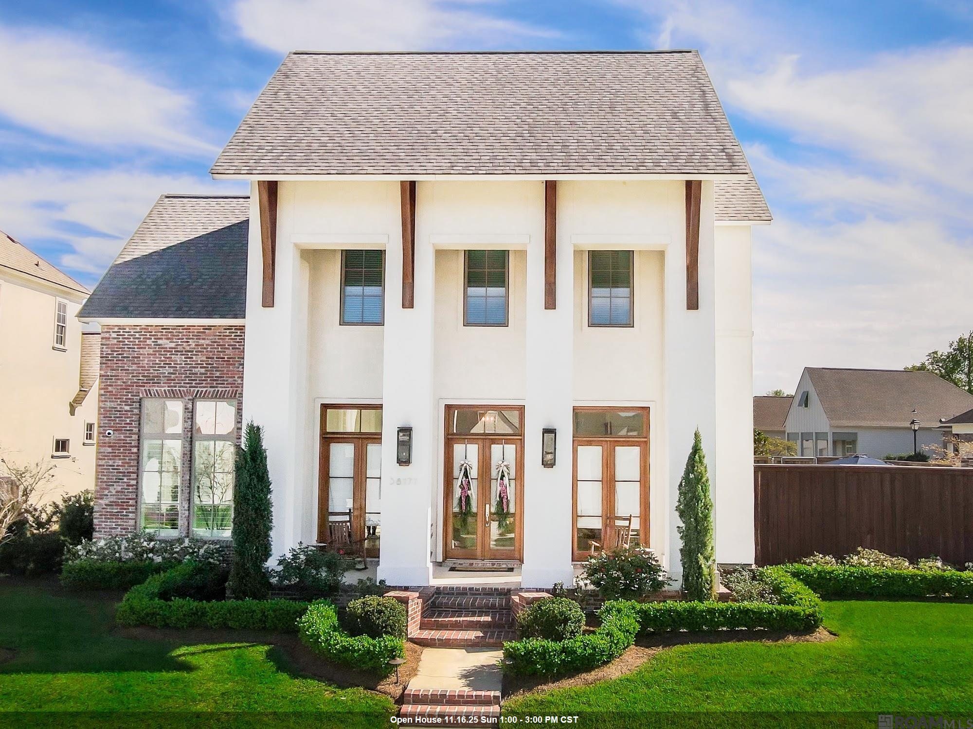 LOCATED ON THE PARISH LINE! Just one mile from Highland Rd/EBR, in the New Ascension Parish Prairieville High School District! Prepare to be impressed by this custom-built, 4 Bd, 3.5 Bath home on a premium corner lot with unmatched outdoor amenities, perfect for entertaining. Enjoy resort-style living centered around a stunning Heated Gunite Pool & Hot Tub featuring full app-controlled automation, decorative deck jets, captivating LED lighting, and a UV filtration system for easy maintenance. The expansive, fully equipped Outdoor Kitchen complements the setting, offering a large, covered patio, operable louvered shutters, a high-end grill, a power burner, and a beautiful brick fireplace. The open interior boasts extensive high-end upgrades: reclaimed wood doors, oak wood floors, 8 ft interior doors, and custom cabinetry. The Chef's kitchen features a Thermador 36-inch 6-burner gas range & fridge, a huge island, walk-in pantry, and a wet bar w/wine fridge. The luxurious Primary Suite includes a custom tiled shower with a rain head, soaking tub, and a closet connected directly to the laundry room. A private office and an additional ensuite bedroom complete the first floor. Located in the amenity-rich Oakland Crossing (community pool, parks, trails, basketball, pickleball). This location offers seamless access to Baton Rouge, I-10, and all services!