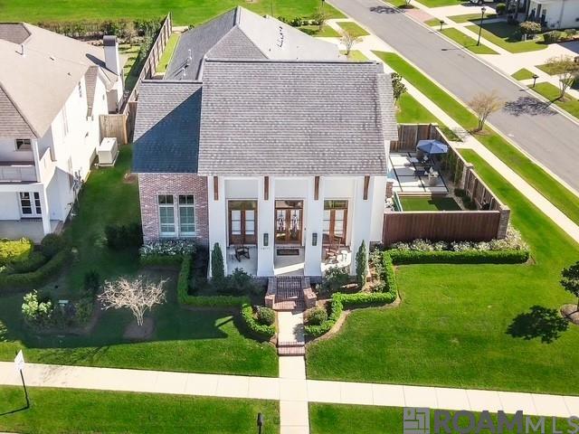 Priced Below Appraised Value! Located in the New Prairieville High School District! Custom Built on a Corner Lot, 4 Bds, 3.5 Baths Sep Office, 3 Car Garage, Gunite Pool w/Hot Tub & Outdoor Living Spaces w/Extensive Upgrades. 2 Story Contemporary featuring a well-designed open floor plan that overflows onto the spacious patio w/fenced-In Side Courtyard Providing Privacy for Pool Area & Fully Equipped Outdoor Kit, w/Operable Louvered Shutters, Grill, Power Burner, Brick Fireplace & Brick Island w/Sink & Seating. Interior Boasts Wood Reclaimed Doors, Oak Wood Floors, 3 CM Counters. 8 Ft Int Doors, Custom Cabs, Cove Crown Molding & Designer Lighting. Chef’s Kit w/Thermador 36 In 6 Burner Gas Range & Fridge. Wood Shaker Soft Close Kit Cabs w/Lighting, Huge Island w/Seating, Butler’s Pantry + Walkin Pantry. Wet Bar w/Wine Fridge. LR w/Brick Fireplace, Built-ins & Formal Dining. Office, Mud Room, Cubbies & Huge Laundry. Primary  Bed/Bath w/Tiled Shower w/Seating, Rain Shower Head & Wall Water Feature. Stand Alone Soaker Tub, w/Wainscoted Wall. Double Vanities & Spacious Closet w/Built-ins Connected to Laundry Rm. Guest 1/2 Bath & Additional EnSuite Bed w/Full Bath, Completes the 1st Floor Living Spaces. Stairwell w/Custom Iron Railing w/Wainscoted Walls Leading to the Upper-Level, 2 Bedrms & Full Bath. Stained Tongue & Grove Pine Ceilings on Patio & Front Porch. Three 16 Sear A/C Units w/10 Year Warranty. Oakland Crossing has Sidewalks, Parks, Walking Trails & Pickleball Ct. Within Close Proximity Baton Rouge, I-10 & All Services Including, Medical Facilities, Health Clubs, Shopping, Dining, Banking, Award-Winning Ascension Parish Schools.