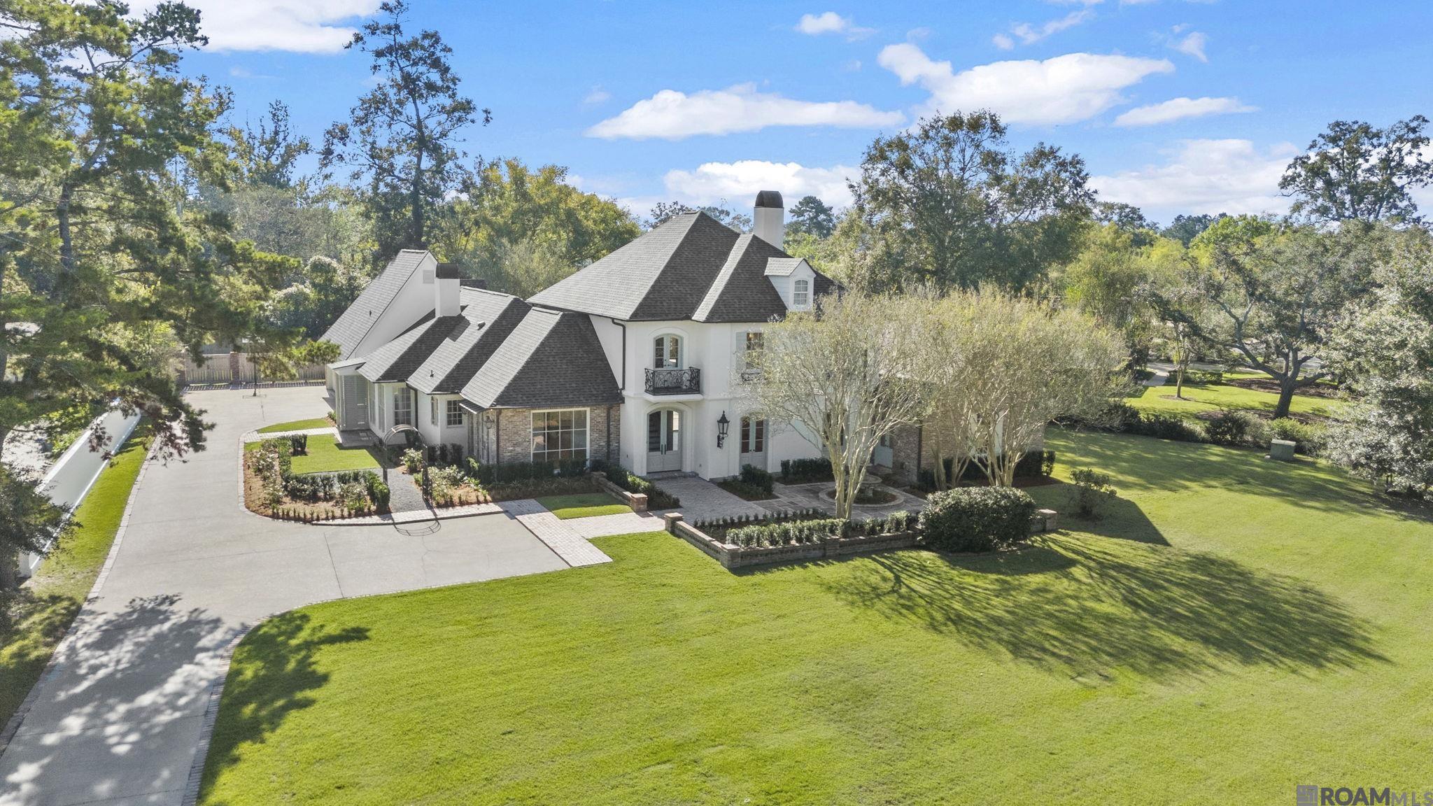 Renovated and ready! Nestled on a prime street in CCLA, this 5 bedroom, 5 bath home with media room and 3-car garage is move-in ready. With interiors designed by Anne McCanless, you'll find updated luxurious materials including quartzite and marble countertops, designer light fixtures and custom cabinetry combined with classic elements of antique cypress beams, antique brick and three fireplaces.   The spacious floor plan features a new kitchen and bar layout with GE Monogram appliance package including a 48" gas range, Sub-Zero wine column, Miele dishwasher and GE cocktail ice maker. Also featured is an adjacent keeping area with fireplace and informal dining area. The primary bedroom and bathroom, and two additional bedrooms each with baths are located downstairs. Upstairs, two large bedrooms and baths are separated by a large living/game room. A separate media room is located over the garage. This home features a 48KW Kohler whole-home generator, roof replaced in 2024, revitalized front and rear courtyards and custom landscaping with irrigation for the entire property.   Residents of CCLA enjoy access to a championship golf course, pool, tennis courts, club house, fitness center and event spaces. This is your opportunity to own a completely updated home in this covetable neighborhood!