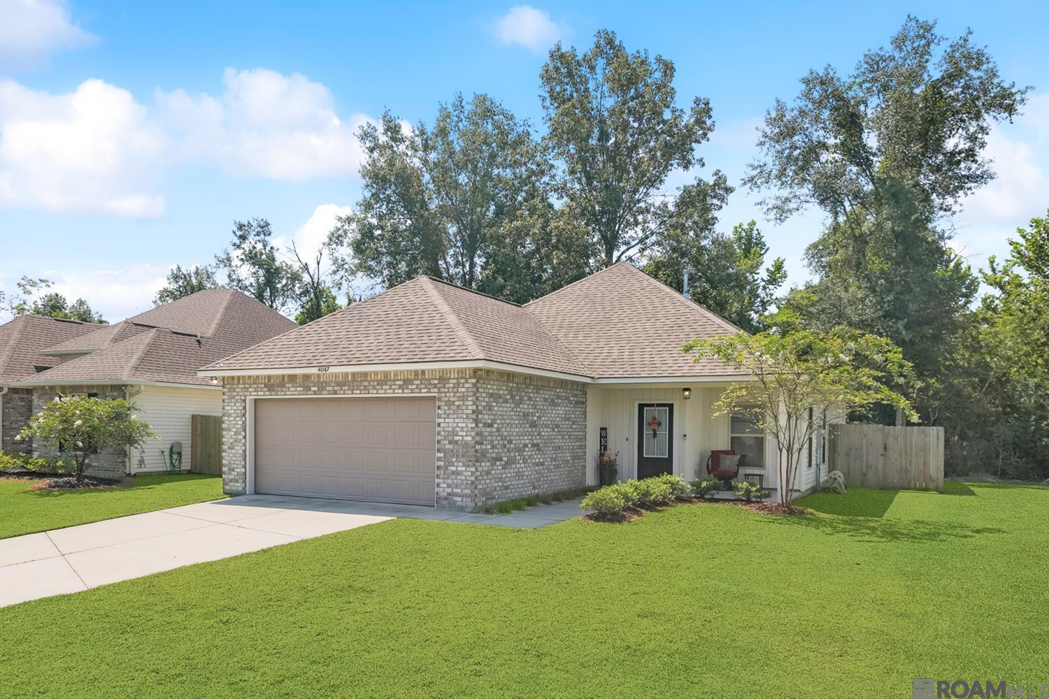 Welcome to 40167 Trace Avenue in Highland Trace—a charming one-street neighborhood in the heart of Prairieville. This home offers 3 bedrooms, 2 full baths, and an open-concept design with a built-in computer desk/nook, perfect for today’s lifestyle. Situated on a quiet cul-de-sac just a short walk to the neighborhood pond, this home combines comfort with convenience.  Step through the foyer into a spacious living, dining, and kitchen area ideal for both everyday living and entertaining. The kitchen features an island, large pantry, and abundant cabinet space. Two guest bedrooms and a full bath are located off the living room, while the private primary suite is tucked away near the back patio. The primary suite includes a spa-like bath and walk-in closet. A mudroom and laundry area are conveniently located off the garage entry.  Upgrades include luxury vinyl plank flooring throughout the living areas, halls, primary suite and closet, plus all wet areas. Energy-efficient features include a tankless gas water heater, Honeywell Smart Connect WiFi thermostat and Low E tilt-in windows.  This home is located in Flood Zone X (no flood insurance required by lenders). Current school assignments per apsb.org are Sugar Mill Primary, Galvez Middle, and Prairieville High.  Don’t miss your chance to own this beautiful home in Highland Trace—schedule your showing today!