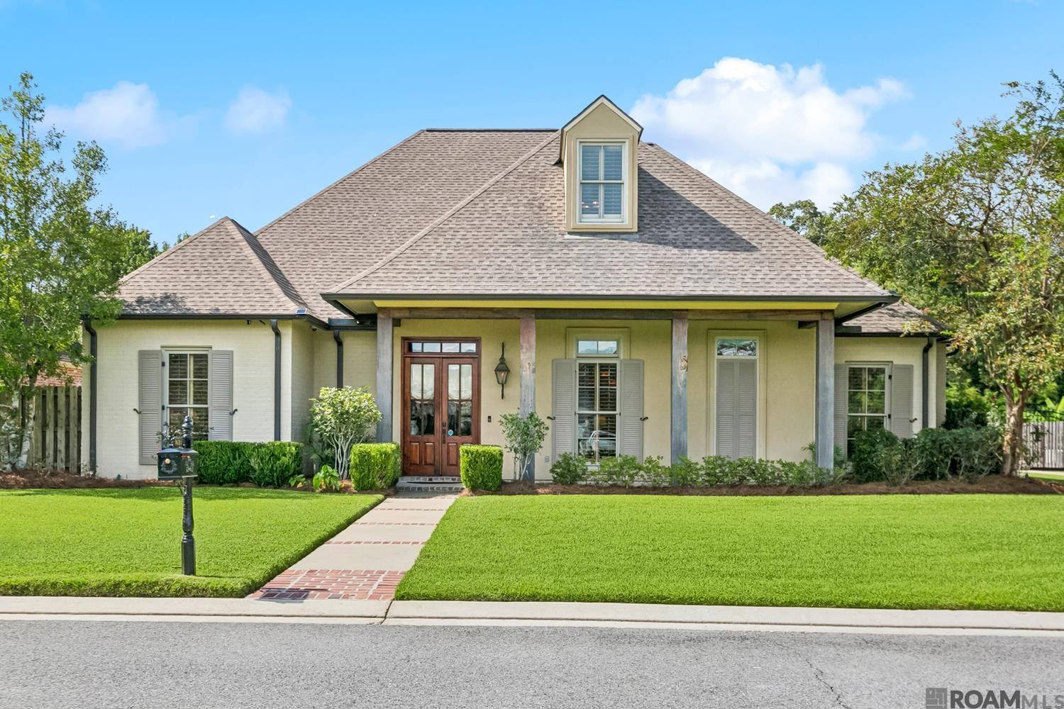 Welcome to LaSalle Pointe, Ascension Parish’s most sought-after gated luxury community. Situated on nearly a half-acre lot, this exquisite residence offers over 3,800 sq. ft. of living space with 4 bedrooms, 4 full baths, and 2 half baths – including a dedicated pool bath – plus a private home office/study. From the oversized foyer, you are greeted by elegant formal dining and living areas, custom ceilings with exposed beams, and architectural details throughout. The gourmet kitchen is a chef’s dream, featuring top-of-the-line stainless appliances including double ovens, an Italian range, and a warming tray. An expansive eat-in island, abundant counter space, and extensive custom cabinetry provide both function and luxury. The first-floor primary suite is a private retreat with space for a sitting area and a spa-inspired en suite bath complete with dual vanities, jetted tub, separate shower, water closet, and a fully customized walk-in closet. A guest suite with private bath is also conveniently located on the main level. The home office sits just off the kitchen for privacy, and the large laundry room includes a sink and broom closet. Upstairs, a spacious den/media room is flanked by two additional bedrooms with a full bath, offering privacy and versatility for family or guests. Car enthusiasts/hobbyists will appreciate the 4-car garage options: a traditional 2-car garage with additional storage and boat port/golf cart storage or 3-car garage with half bath, plus a detached California-style garage with roll-up door that doubles as a gym, workshop, or perfect for parties poolside. Above the garage, a 250+ sq. ft. flex/bonus room (heated & cooled) adds additional living or recreational space. The outdoor amenities rival any resort: a Gunite pool with fountains, fully screened patio with outdoor kitchen and wood-burning fireplace,mosquito misting system and generator. This home combines luxury, functionality and exceptional outdoor living. Call today!