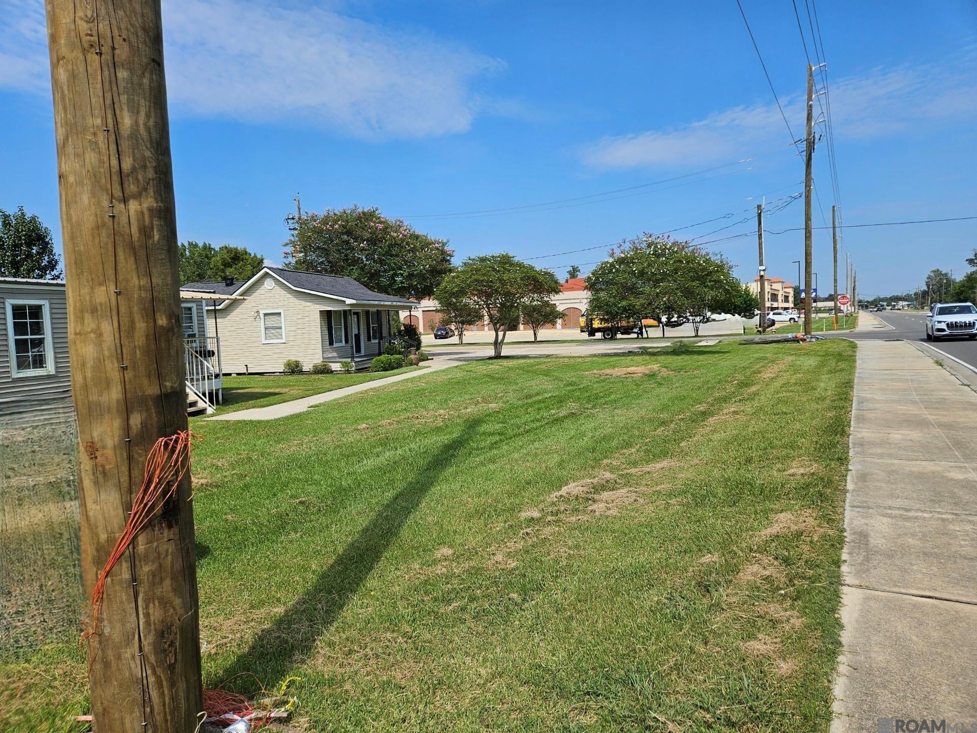 Vacant Land...Commercial hard corner lot on high traffic La. Hwy 42 in Prairieville, LA.  Approximately 1.12 Acres cleared land.  All buildings will be removed for your immediate build.  The small home and trailers are not part of the Sale Price.  Located next to the Prairieville Library with a turning lane already in place.  Convenient to major businesses such as Rouses, Galvez Hardware Store, Walmart Market Place, Fast food restaurants, Walgreens, Oreilly's and so much more.