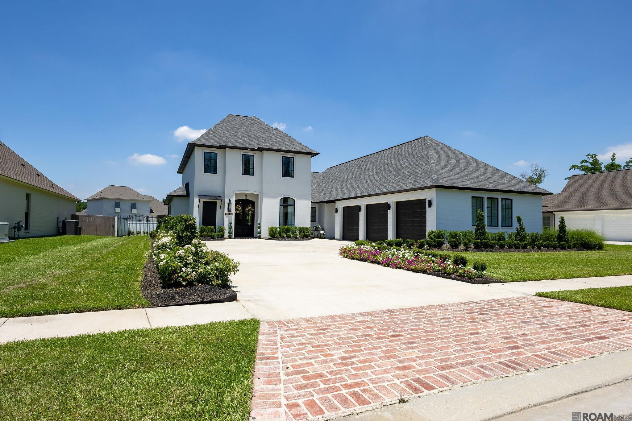 CUSTOM LUXURY HOME WITH HEATED GUNITE POOL & SPA! Upscale, custom built home loaded with extensive enhancements in prestigious Oaks on the Bluff Estates & Top Ranked School District! Enter into the inviting foyer which showcases the large, open concept design with adjacent formal dining room adorned with coffered ceilings, cypress wood beam, recessed lighting & enhanced crown molding. The spacious living room features a sleek ventless gas fireplace with quartz surround & stunning custom wood wall design on each side plus adequate enclosed storage areas! The gorgeous gourmet kitchen features Stainless Viking Appliances, oversized gas stove with grille, beautiful quartz countertops, oversized waterfall island with massive counter space and built in microwave, wall oven, dishwasher & beverage fridge! Plus custom elongated cabinetry with glass inserts with an enhanced design, gold hardware, marble tile backsplash & pot filler. The spacious primary bedroom offers tons of natural light and backyard views! Primary bath features custom tiled shower with dual sprayers, glass seamless door, free standing garden tub & separate dual vanities w/ quartz counter tops, framed mirrors and undermounted sinks! Two large custom closets with organization system already included for handbag & shoe display thoughtfully designed for maximum functionality. Downstairs also offers an additional bedroom plus office or 6th bedroom, a full bath plus half bath and storage! Upstairs features 3 bedrooms, a Jack & Jill bath, bonus room & half bath! The impressive backyard offers a custom outdoor kitchen w/ granite top, Hibatchi Grill, Comado Joe Ceramic Grill, beverage fridge, sink, trash drawers & large seating space with ceiling fans & ventless gas fireplace. The heated custom gunite pool with spa surrounded with exquisite landscape design, irrigation system, uplights & gutters adds the perfect final touch! Conveniently located near interstate & great schools! No flood insurance required!