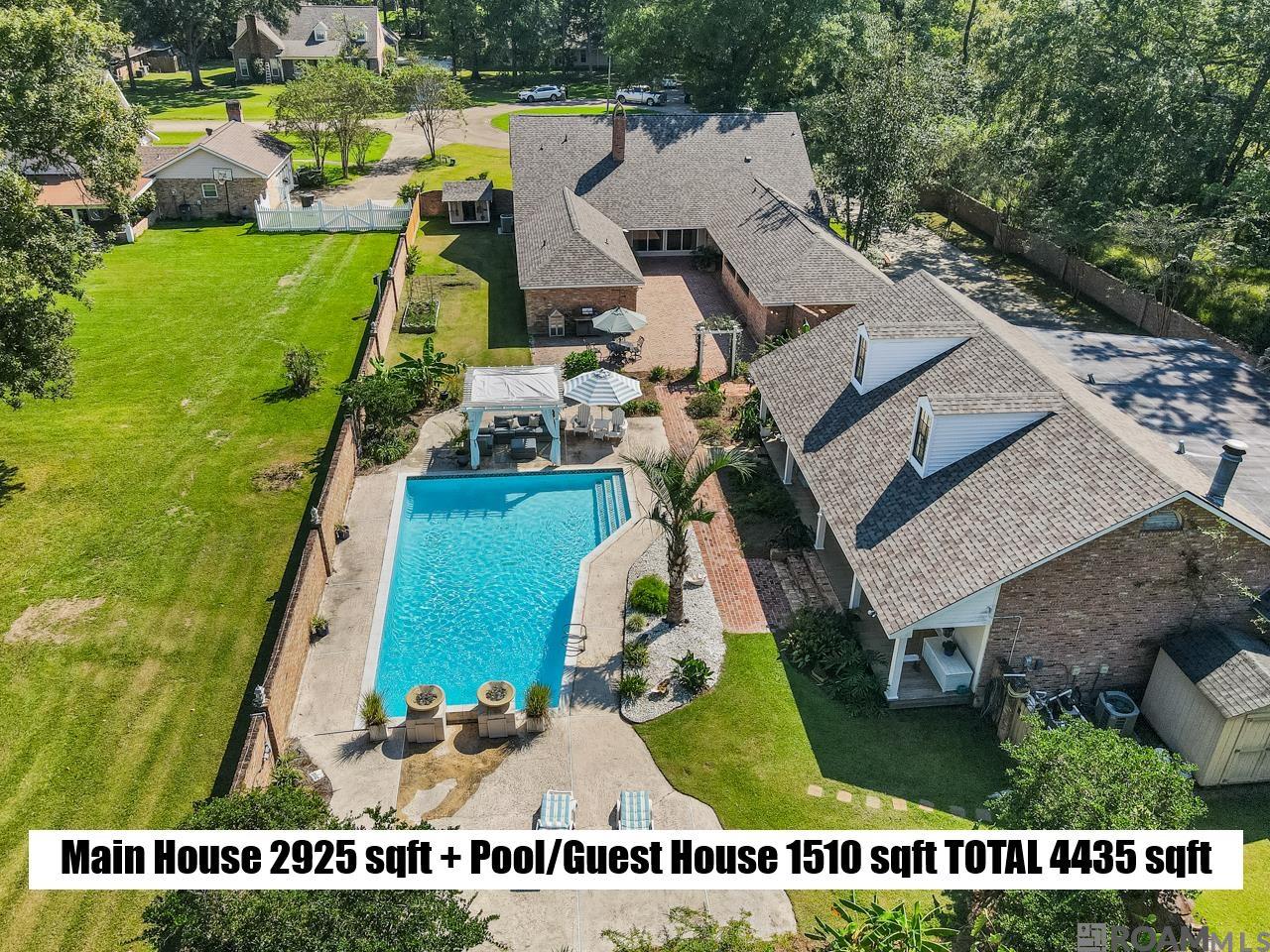 ESTATE living at its best in Central. MAIN HOUSE  features 4 BR/ 2.5 bath, and detached POOL/GUEST HOUSE (additional 1510 sf living area) features a full kitchen, 1 bath, and can sleep 6. Both houses have been completely updated and remodeled. Special features in main house include a full Acadian front porch, movie theater/media room, abundance of floored attic space, all closets have built ins so dressers not needed in bedrooms, oversized patio, New Orleans style courtyard with beautiful landscaping and a large gunite pool with double water fountains, beckoning you to swim or just relax. The pool/guest house faces the pool & courtyard and features a pool table inside as well as a boat port/288 sf garage and abundant exra storage. This RETREAT is located on a cul-de-sac with gated driveway and brick fence around the entire property for ultimate privacy. BRAND NEW ROOF installed to both houses in September, 2025.  And wait, even more goodness - Flood Zone X so flood ins not required! Schedule your showing today!