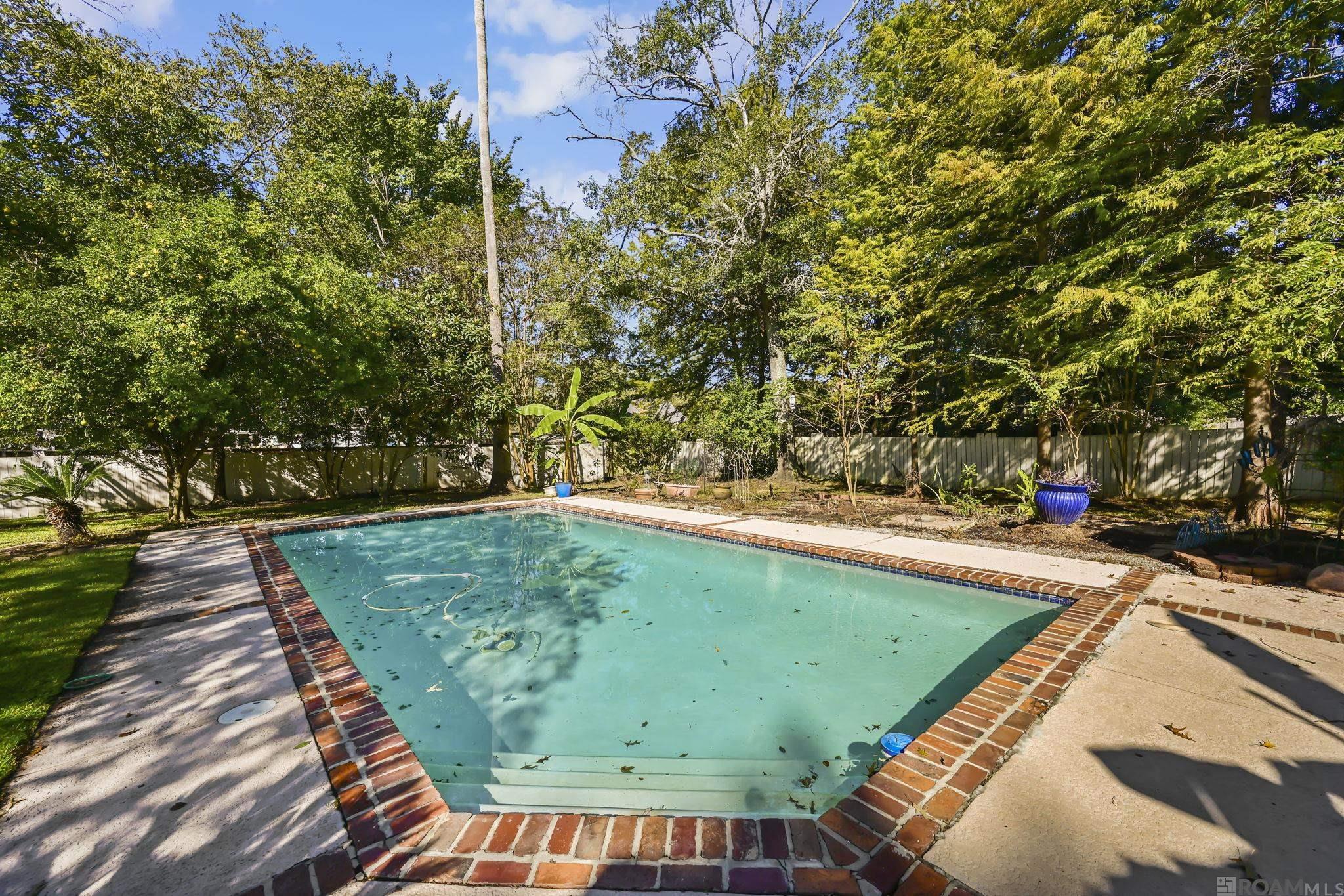 Welcome to your ideal one-level retreat — a beautifully updated 4-bedroom family home PLUS OFFICE perfectly positioned on a desirable corner half-acre lot in Riverbend, featuring a sparkling pool & gorgeous refreshed interiors. From the moment you arrive, you’ll be drawn to its exceptional curb appeal — a wrap-around lawn with mature landscaping, a welcoming front porch, & a layout that offers both space and privacy. The corner location enhances natural light, provides convenient side yard access, & creates an inviting sense of openness not found on typical interior lots. Step into the backyard & discover your private oasis: an in-ground pool surrounded by an expansive pool deck, ideal for relaxing weekends or lively gatherings. The fully fenced yard ensures both safety & seclusion — perfect for families & pets alike. Inside, the home unfolds with a traditional yet open layout that connects the living room, dining area, & kitchen — an effortless flow designed for today’s lifestyle. The updated kitchen showcases sleek Taj Mahal quartzite countertops, a coordinating tile backsplash, stainless steel appliances, & ample cabinetry with island seating for casual dining or homework sessions. A cozy breakfast nook and a formal dining area offer flexibility for both everyday meals & special occasions. Down the hall, four well-proportioned bedrooms provide privacy & comfort. The primary suite is a serene retreat filled with natural light, featuring his-and-hers walk-in closets & a spa-inspired en suite bath with dual vanities, updated tilework, & a frameless glass shower. The additional bedrooms are bright and versatile — ideal for children, guests, or a dedicated home office. With its single-story layout, modern updates, & prime corner lot setting, this home blends comfort, functionality, & timeless style. This Riverbend residence is designed for real life — beautifully lived.