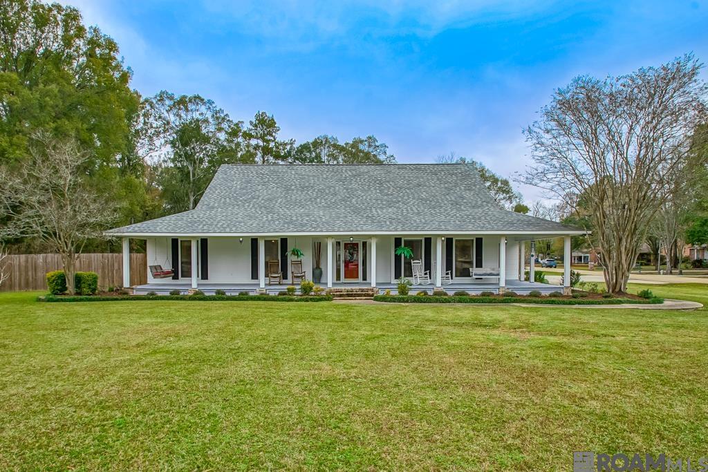 Charming white Acadian home in Central School District on a spacious 1.25-acre corner lot with expansive porches and major upgrades. Owners invested heavily in ditch piping & drainage improvements, fresh landscaping, and a new fence. Features a huge RV port with its own driveway on double lot, plus two additional covers for a boat or toys. Roof replaced in 2020 and bathrooms upgraded. The master has a sitting room and the living room has a sunroon leading to the back patio/pool. Includes a 3-car garage, with the third stand alone garage used as a workshop with its own bath, plus a 19x27 lean-to for extra storage. Out back, enjoy the large stamped-and-scored covered patio overlooking an oversized L-shaped pool with a newer liner. Move-in ready with space, privacy, and exceptional outdoor amenities.