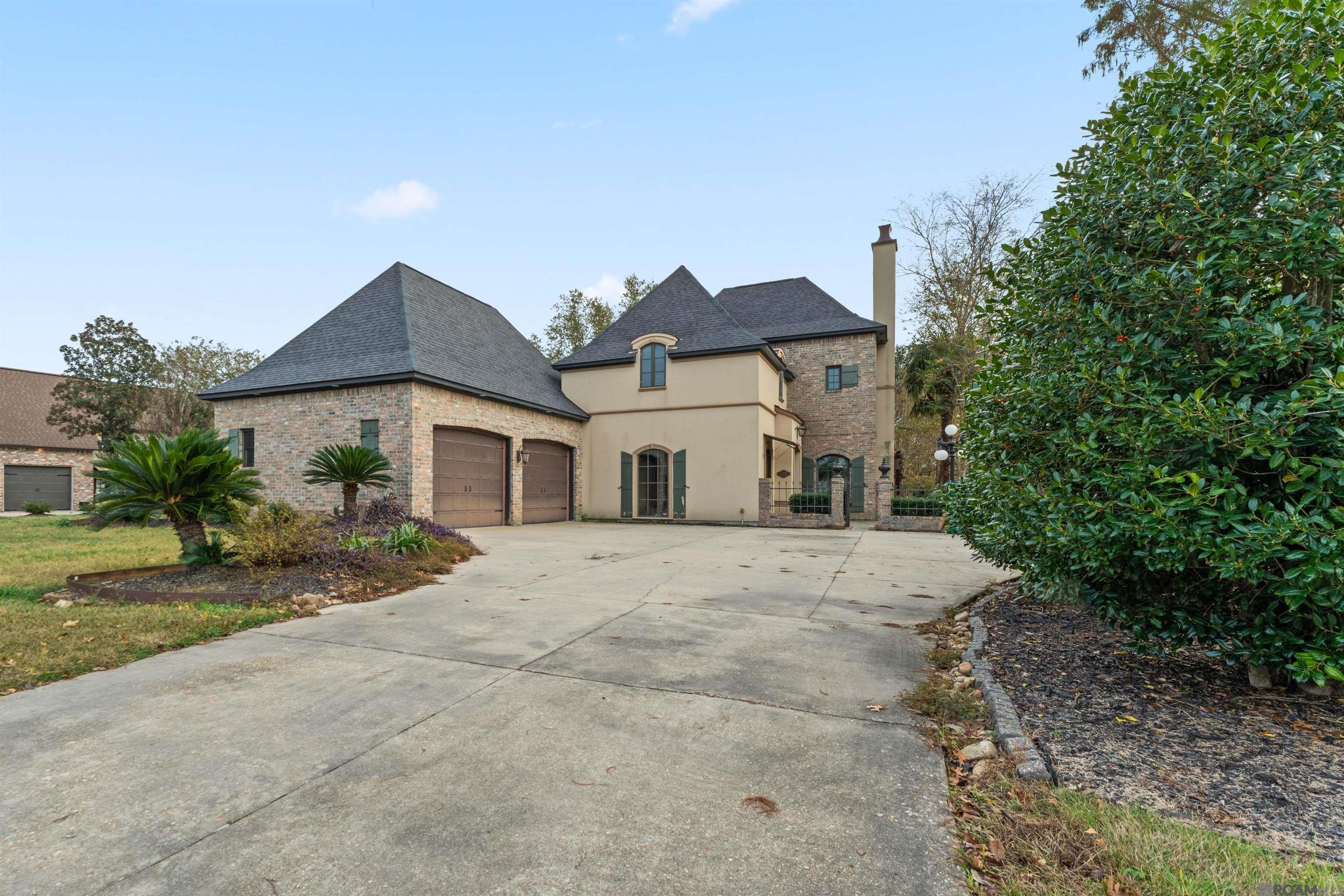 Tucked away on a quiet dead end street, this 4 bedroom 3 bath home with a bonus room sits on a large golf course lot. Walk through a gated entry that opens to a courtyard and leads to the front door. The large living/dining room has wood floors, a ventless brick fireplace and 2 sets of double doors that open to the backyard. The Gourmet kitchen features beautiful interior brick walls, brick paver flooring, custom cabinetry, a corner sink that overlooks the side courtyard, a center island, and large pantry storage situated under the staircase. The primary bedroom is located on the first floor with a personal fireplace and private entrance to the back patio through double doors. The en suite bathroom has a walk-in shower, double vanities with sitting area and a walk in closet with built-ins. Also on the first floor is another bedroom with its own entrance to the front courtyard, a full bathroom and a large laundry room with built-in cabinetry and large farmhouse sink. On the second floor there are 2 bedrooms and a full bathroom as well as an open den area that could be used as an in-home office and there is access to a balcony that looks out over the backyard and golf course. There is also a large bonus room upstairs with additional closet storage. The backyard is fully fenced with beautiful mature trees, a water fountain, brick seating area, and access to the side courtyard and the front courtyard. Call to schedule your showing today!